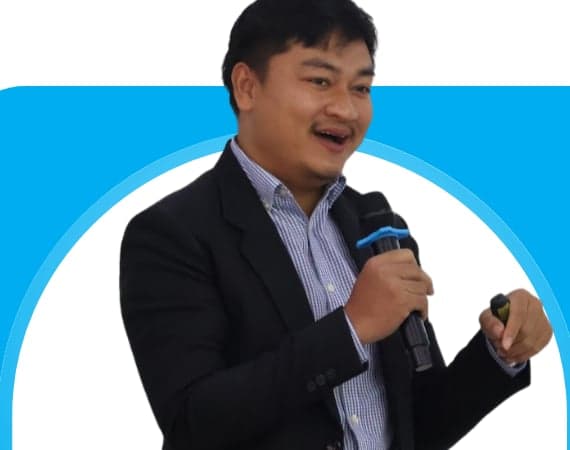 Portrait of Mr Phonsavanh Chindamany, Social Development Manager at Mekong Timber Plantations Co., Ltd., speaking with a microphone during a session on environmental project management.